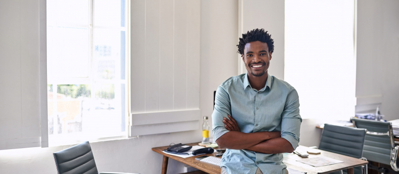 Confident young African American leader depicting confidence after attending young adult youth leadership programs or youth development programs.